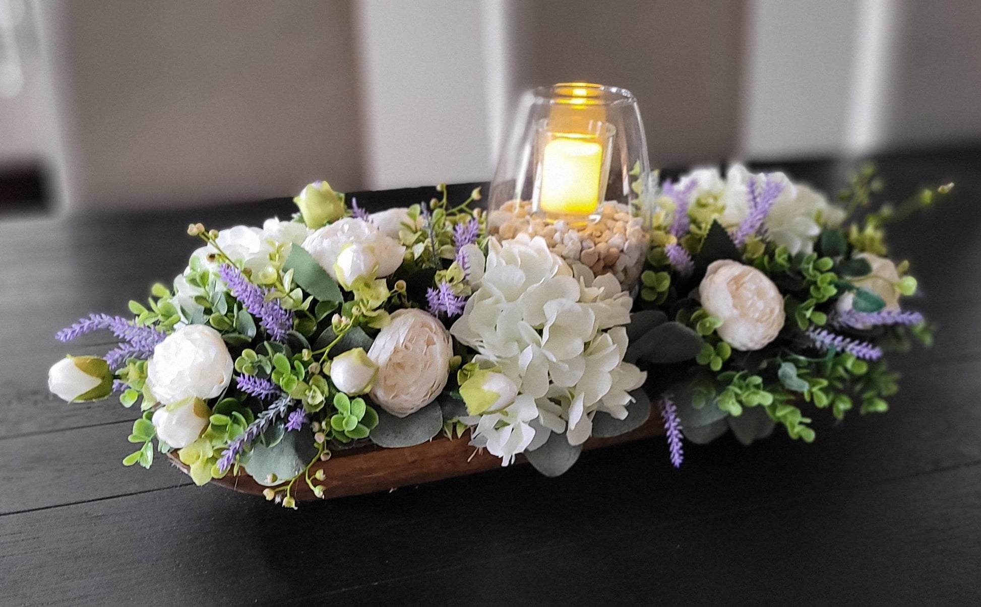 Faux Flower Centerpiece Spring Table Arrangement Peony Hydrangea Lavender Collection Wooden Dough Bowl Design Elegant Dining Display Glass Hurricane Candle Feature Rustic Home Accent Handcrafted Floral Creation Spring Celebration Decoration
