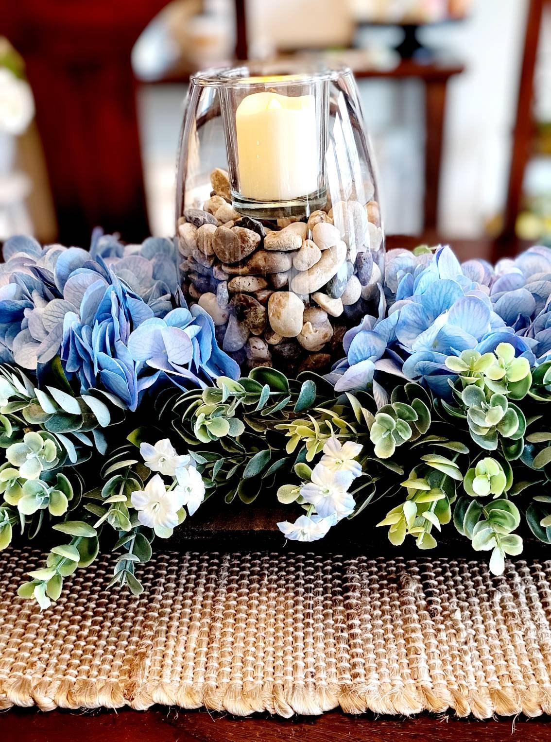 Modern Rustic Display Black Bowl Centerpiece Blue Hydrangea Arrangement Farmhouse Table Decor Wooden Dough Bowl Design Country Style Accent Natural Stone Elements Glass Vase Feature Votive Candle Highlight Nineteen Inch Size Dining Table