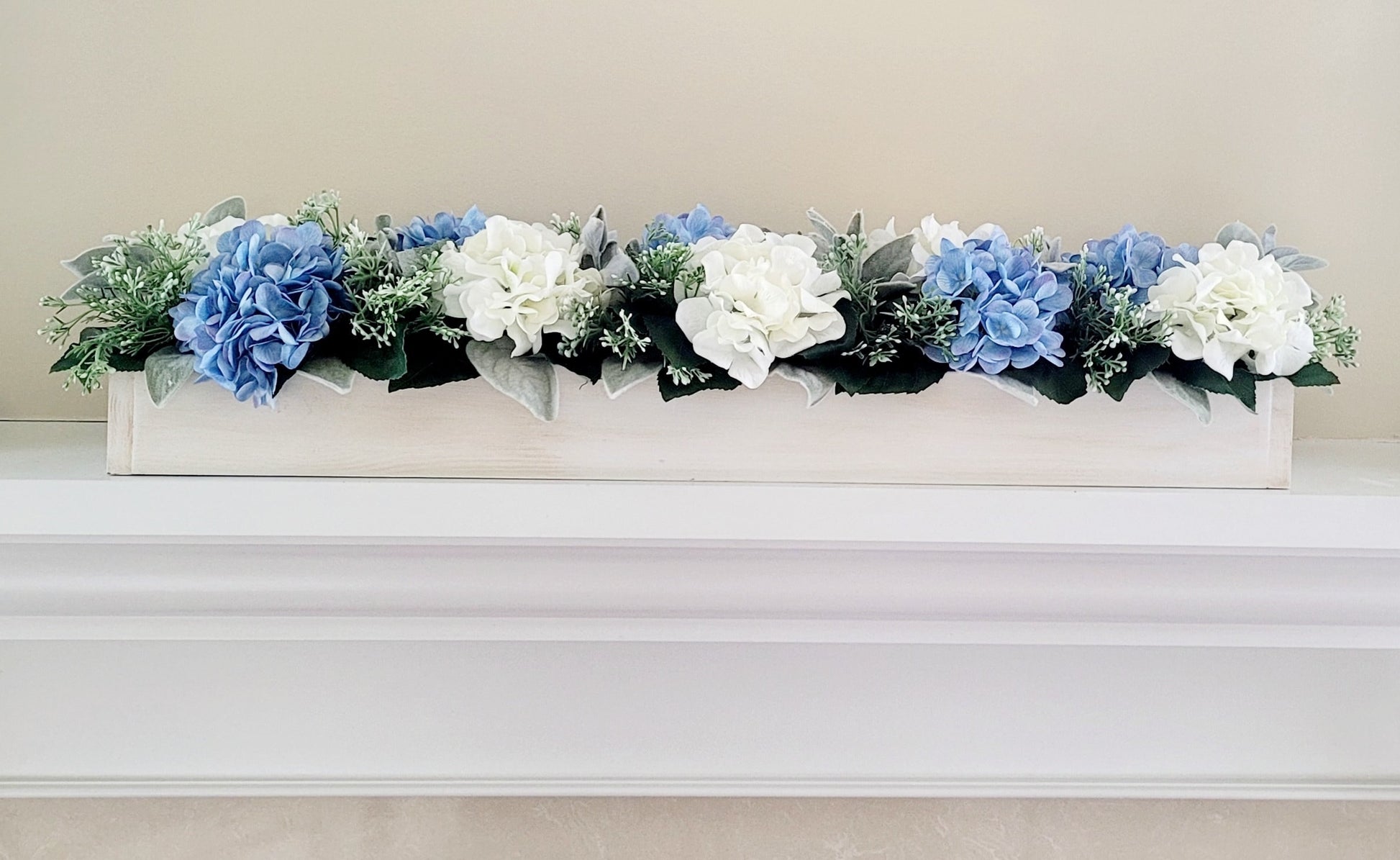 Long Centerpiece Arrangement Blue Hydrangea Wood Box Display Farmhouse Dining Table Styling Rustic Mantel Accent White Wash Finish Custom Box Design Cream Flowers Light Blue Blooms Lambs Ear Greenery Perfect Wedding Reception Centerpiece