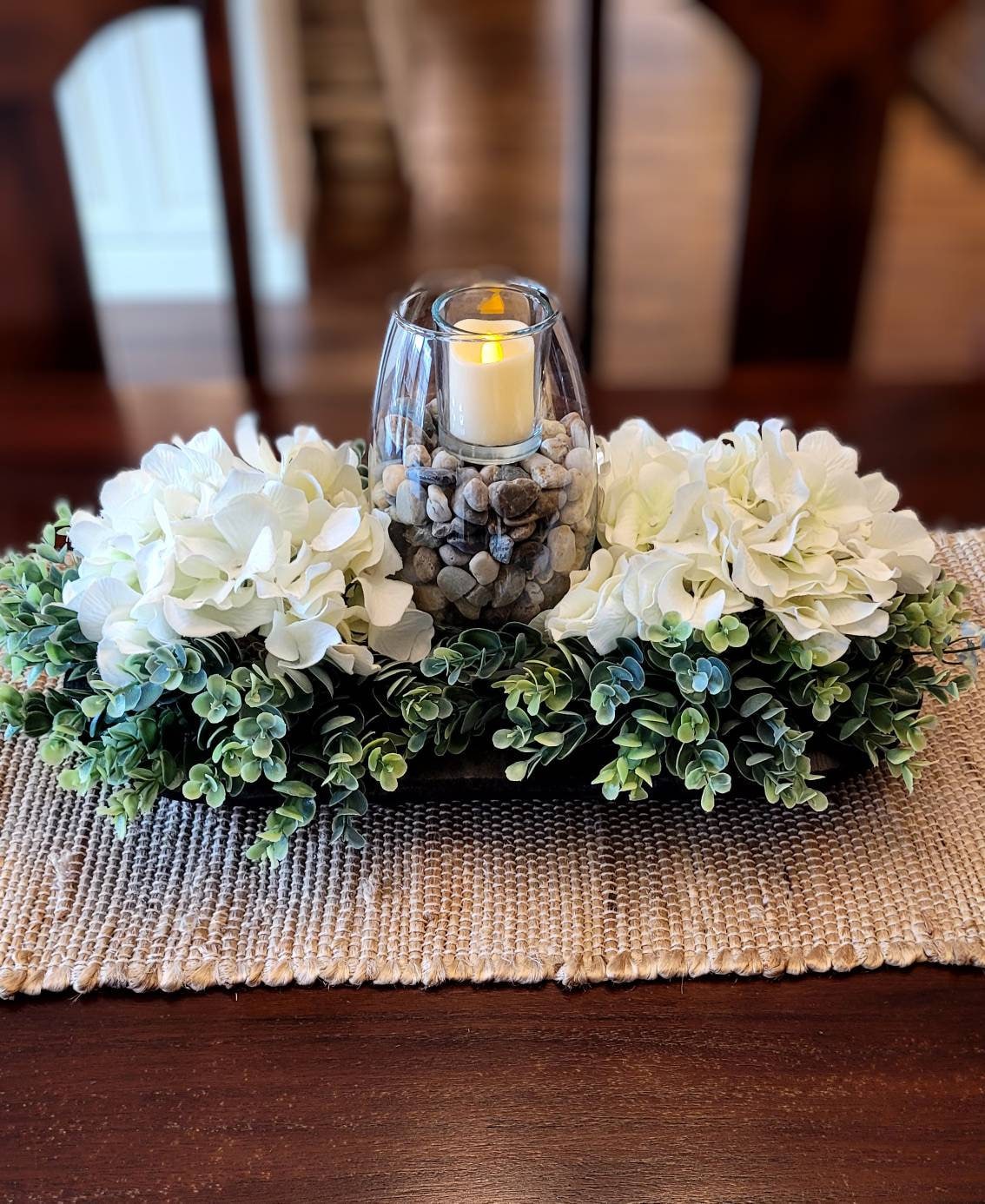 Dining Table Centerpiece Black Dough Bowl Design White Hydrangea Flowers Votive Candle Arrangement Rustic Farmhouse Decor Wooden Bowl Display Earth Tone Rocks Accent Seventeen Inch Length Ready Display Home Decoration Piece Country Style