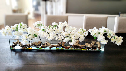 Handcrafted Floral Arrangement White Orchid Display Dining Table Centerpiece Natural Driftwood Element Glass Oval Container Modern Home Decor Elegant Silk Flowers Unique Designer Creation Maintenance Free Beauty Contemporary Style Accent