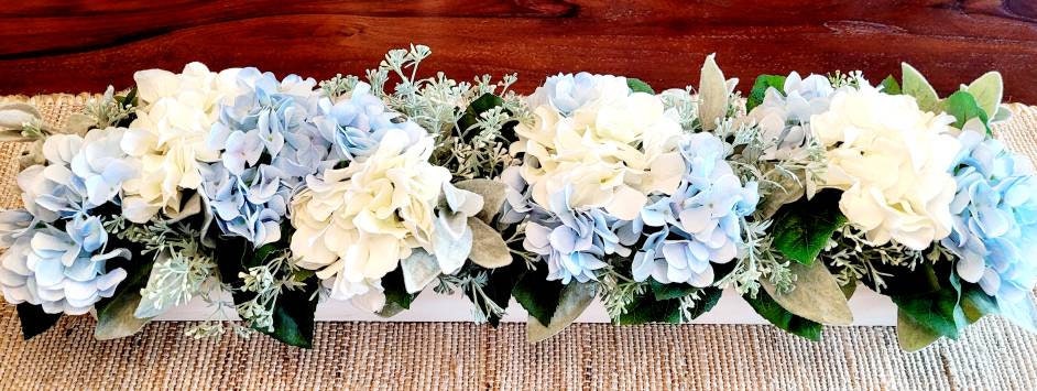 Farmhouse Style Centerpiece Blue Hydrangea Long Wood Box Arrangement Custom Handcrafted Display White Wash Finish Rustic Table Styling Cream And Light Blue Flowers Lambs Ear Greenery Accents Perfect Dining Room Mantel Display Elegant