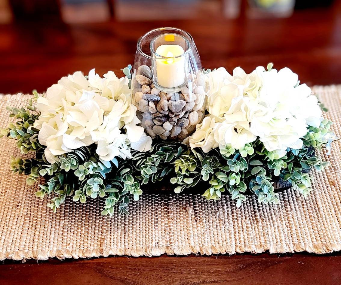 Black Dough Bowl Centerpiece Farmhouse Style Arrangement White Hydrangea Flowers Votive Candle Holder Rustic Table Decor Dining Room Accent Seventeen Inch Length Wooden Bowl Design Earth Tone Rocks Beautiful Home Decoration Ready Display
