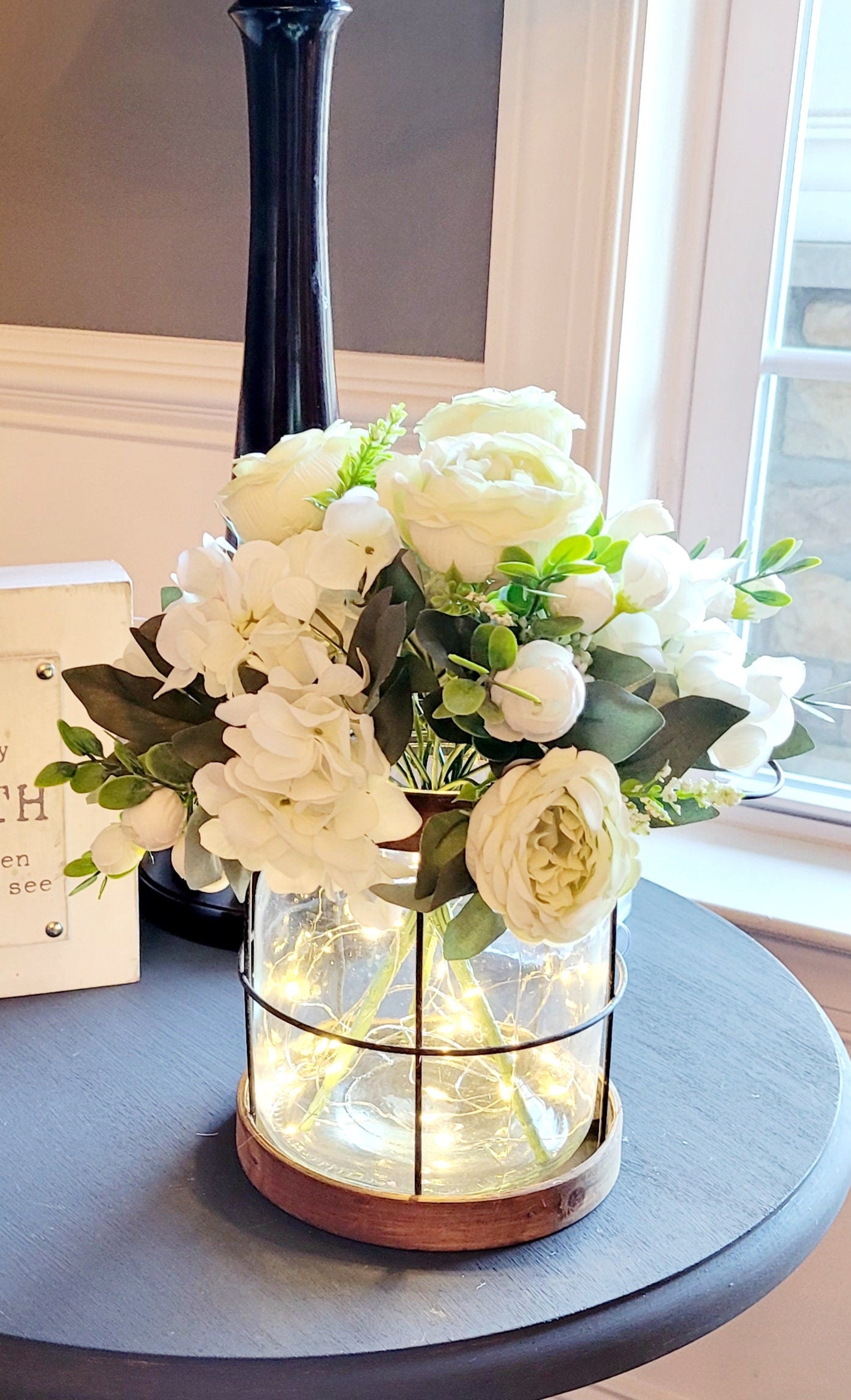Illuminated Farmhouse Lantern Fairy Light Display Floral Centerpiece Arrangement Artificial Peony Roses Mint Green Ivory Color Scheme Rustic Home Decor Year Round Table Display Living Room Accent Piece Romantic Ambient Lighting Country