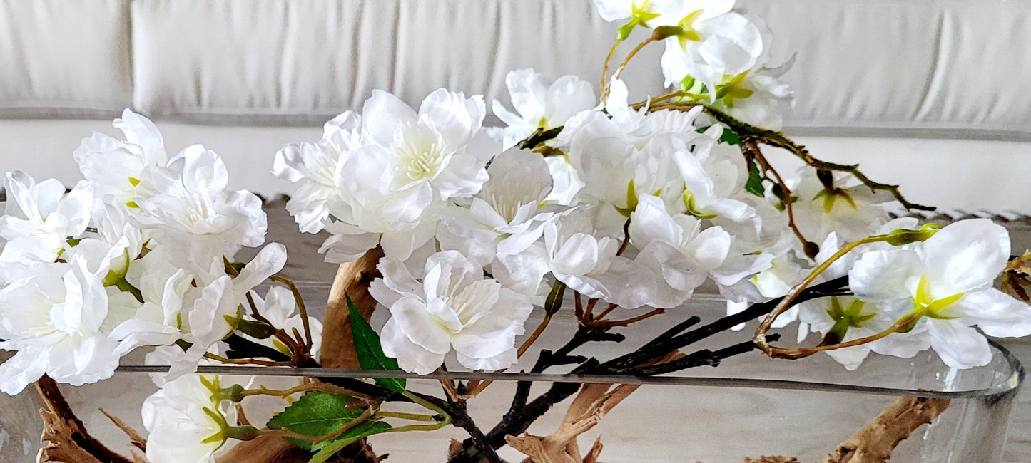 Contemporary Home Decor White Orchid Centerpiece Dining Table Arrangement Natural Driftwood Feature Glass Oval Vase Design Modern Floral Display Handcrafted Artistic Creation Elegant Table Setting Maintenance Free Beauty Unique Conversation