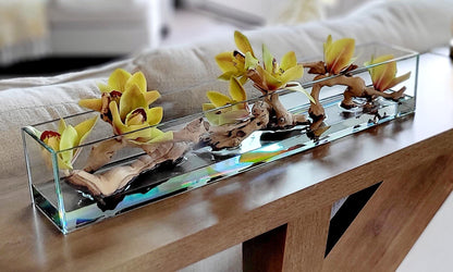 Artificial Orchid Centerpiece Glass Vase Arrangement Yellow Green Silk Flower Display Dining Table Styling Modern Home Accent Driftwood Natural Stone Elements Rectangular Container Design Contemporary Living Room Coffee Table Focal Point