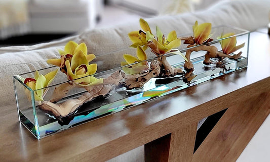 Artificial Orchid Centerpiece Glass Vase Arrangement Yellow Green Silk Flower Display Dining Table Styling Modern Home Accent Driftwood Natural Stone Elements Rectangular Container Design Contemporary Living Room Coffee Table Focal Point