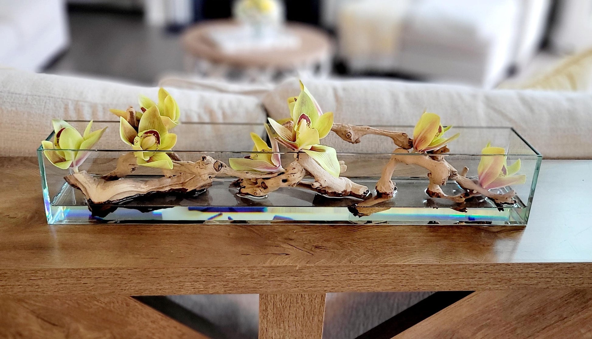 Glass Vase Centerpiece Artificial Orchid Arrangement Modern Table Styling Silk Flower Display Yellow Green Blooms Driftwood Accent Pieces Natural Stone Collection Rectangular Container Design Dining Room Coffee Table Console Entryway