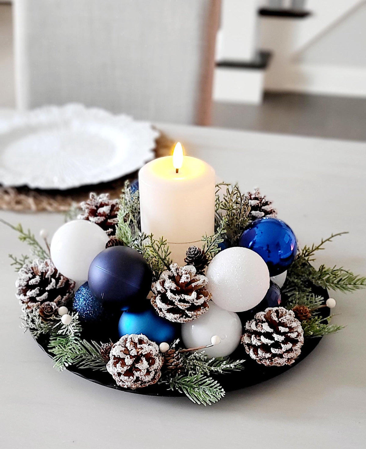 Rustic Christmas Centerpiece Winter Table Candle Arrangement Handcrafted Farmhouse Holiday Display Festive Pine Greenery Natural Pinecones Red Ornament Collection Seasonal Dining Focal Point Traditional Styling Modern Appeal Warm Inviting