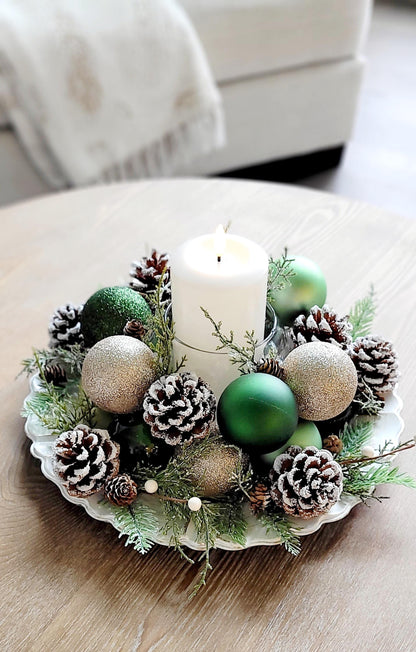 Rustic Christmas Table Centerpiece Handmade Holiday Styling Farmhouse Pinecone Arrangement White Candle Holder Display Natural Evergreen Sprigs Gold Red Ornament Styling Festive Dining Room Setting Winter Season Home Styling Traditional