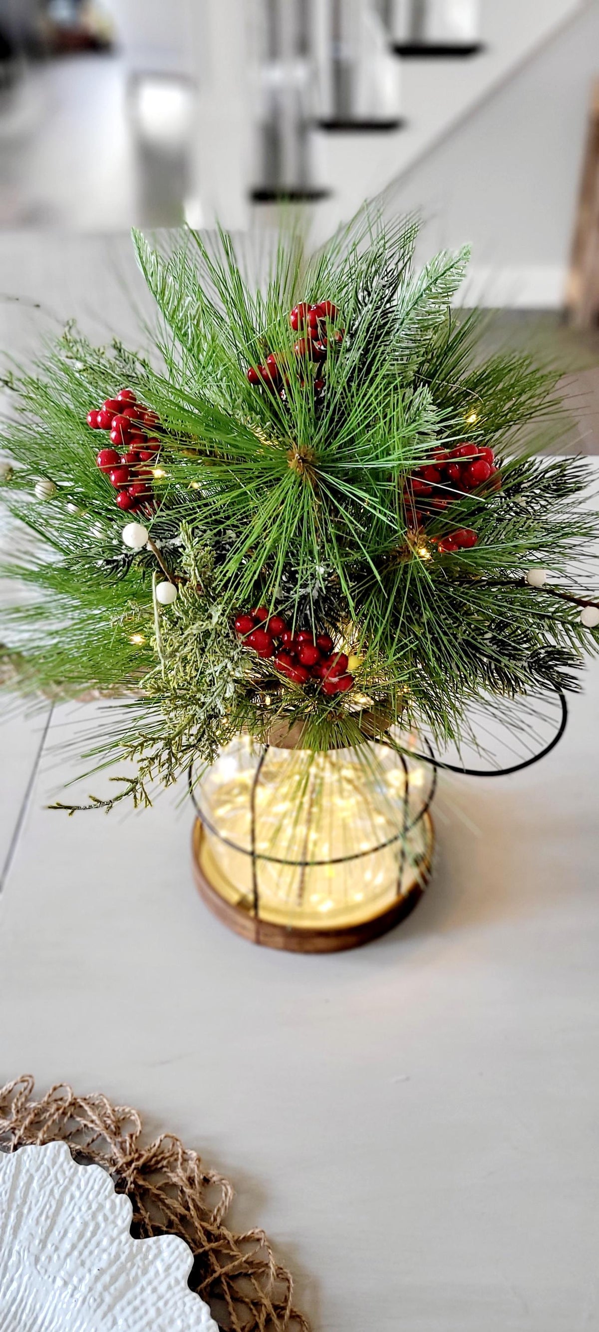Lighted Christmas Lantern Farmhouse Holiday Centerpiece Rustic Winter Table Arrangement Pine Berry Accents Warm Twinkling Lights Indoor Seasonal Home Styling Cozy Festive Display Country Dining Room Mantel Console Natural Greenery Red Berry