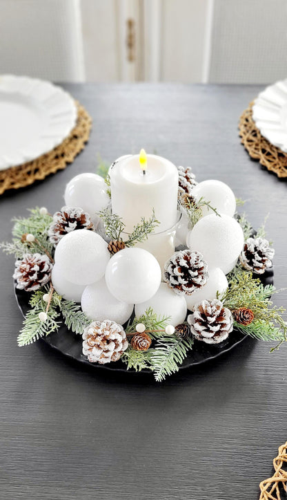 Farmhouse Christmas Table Centerpiece White Pillar Candle Display Frosted Winter Styling Snow Dusted Pine Cones Natural Evergreen Sprigs White Berry Accents Elegant Holiday Dining Setting Rustic Winter Wedding Styling Scandinavian Christmas