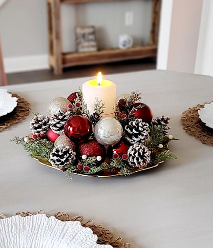Christmas Centerpiece Farmhouse Style Holiday Table Arrangement Rustic Red Candle Holder Display White Pillar Candle Gold Base Frosted Pinecones Glittery Ornaments Evergreen Sprigs Festive Winter Seasonal Styling Ready Made Christmas Gift
