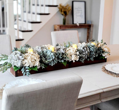 Rustic Wooden Box Centerpiece With Artificial Hydrangea Arrangement Blue Cream White Flowers And Greenery Eucalyptus Lambs Ear Foliage Three LED Candles Integrated Design Perfect Dining Table Display Everyday Home Styling Neutral Color